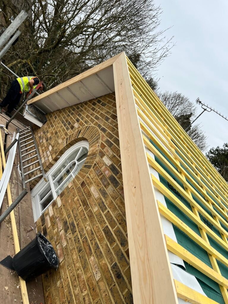 Dormer side with new timber framing and roof battens during works in Hounslow