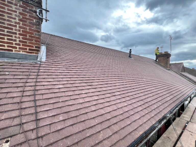 Brown plain-tile roof slope with chimney in Hounslow