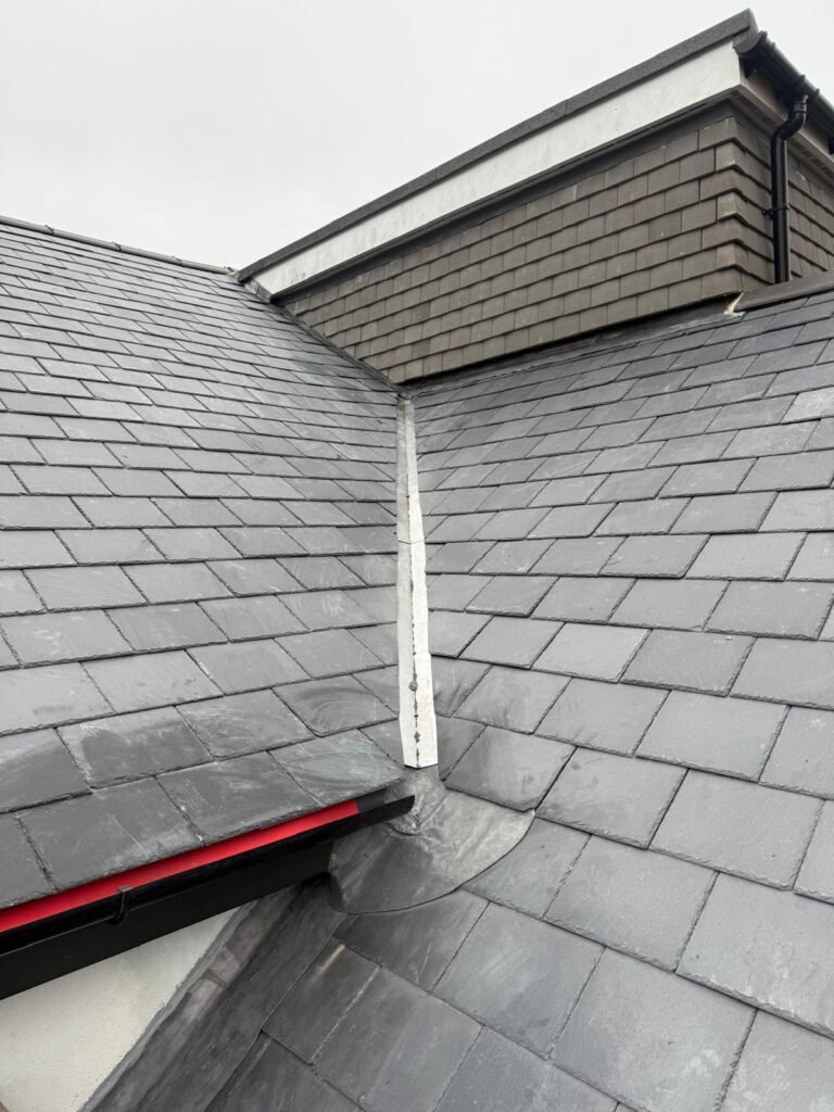 Slate-clad dormer cheek and roof slope with lead detail in Hounslow