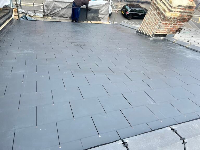 Grey slate-effect covering on a low-pitched roof in Hounslow