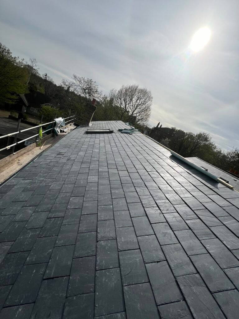 Slate roof slope in sunlight after works by Aulakh Roofing in Hounslow